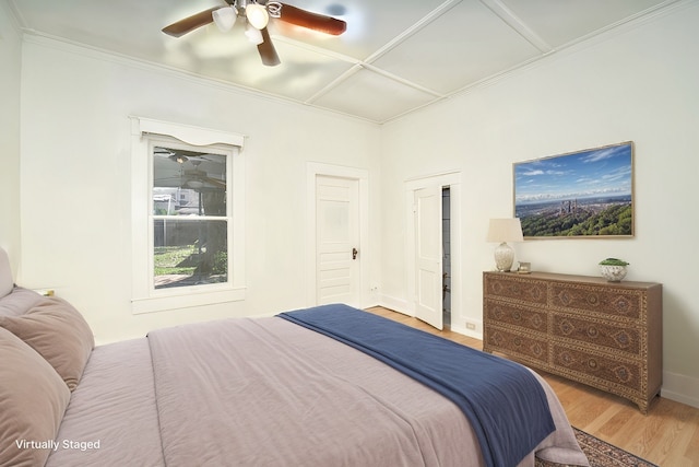 bedroom featuring ceiling fan, wood-type flooring, and ornamental molding