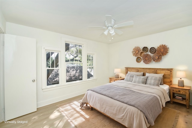 bedroom with ceiling fan and light wood-type flooring