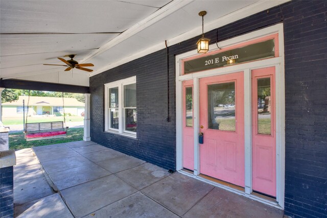 doorway to property featuring ceiling fan and covered porch