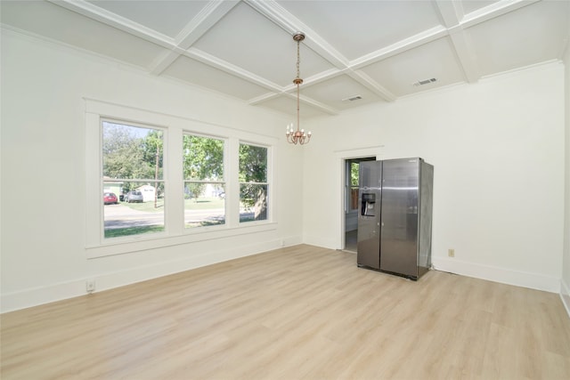 unfurnished room with beam ceiling, an inviting chandelier, coffered ceiling, and light wood-type flooring