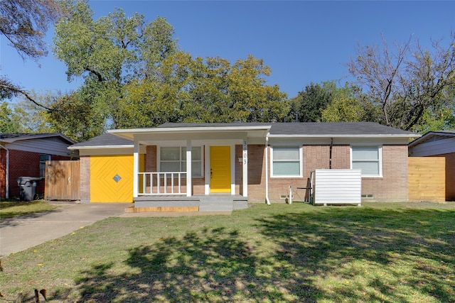 single story home with a front lawn and covered porch