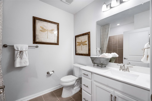 bathroom with vanity, tile patterned floors, and toilet