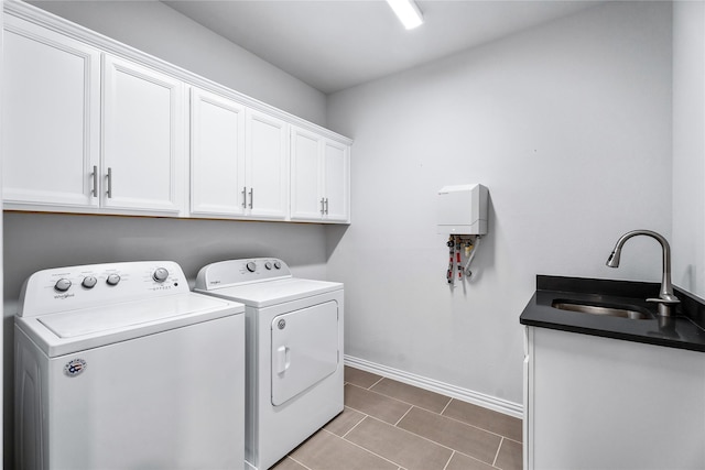 washroom with cabinets, separate washer and dryer, sink, and tile patterned floors