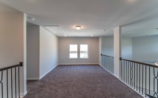 carpeted empty room with ceiling fan and a textured ceiling