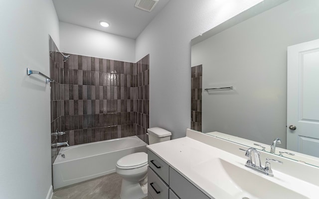 full bathroom with vanity, tiled shower / bath combo, and toilet