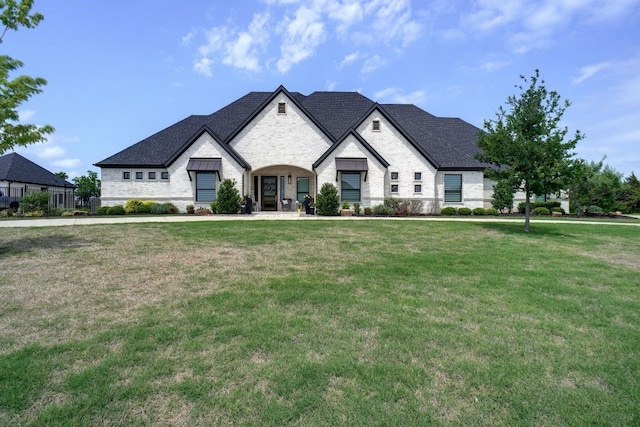 french country style house with a front lawn