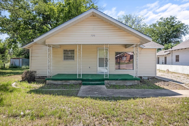 bungalow with a front lawn and a porch