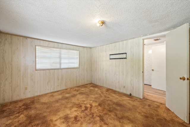 empty room with a textured ceiling and hardwood / wood-style flooring