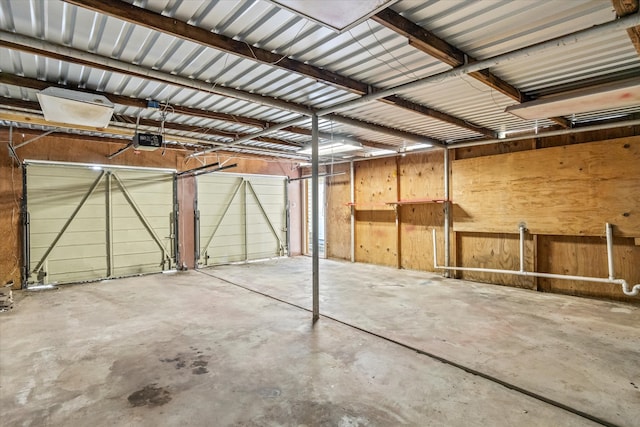 garage with wooden walls and a garage door opener