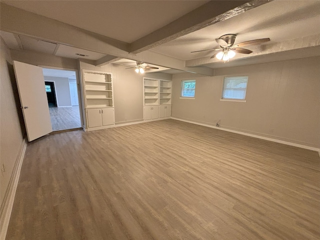 interior space featuring ceiling fan, beam ceiling, and hardwood / wood-style floors