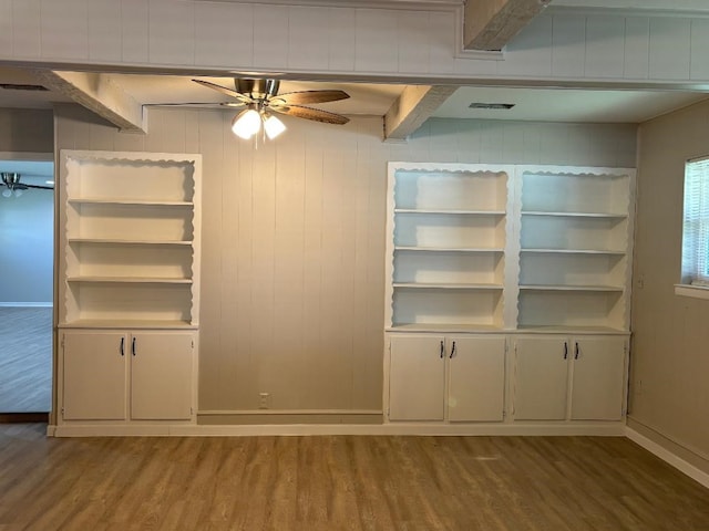 interior space featuring beam ceiling, hardwood / wood-style floors, and ceiling fan