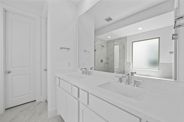 bathroom featuring a shower with door and vanity