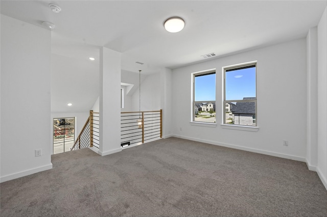 carpeted empty room with a healthy amount of sunlight