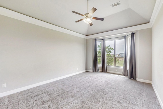 carpeted spare room with a tray ceiling, ceiling fan, crown molding, and vaulted ceiling