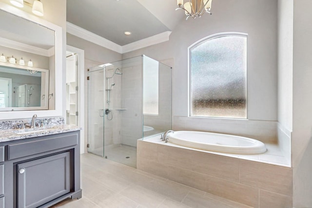 bathroom with a chandelier, vanity, vaulted ceiling, and independent shower and bath