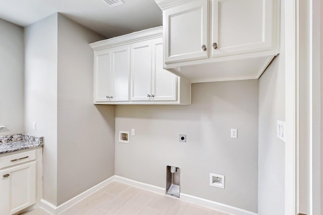 laundry area with electric dryer hookup, hookup for a washing machine, and cabinets