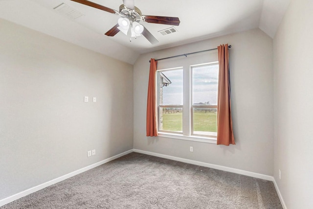 carpeted spare room with vaulted ceiling and ceiling fan