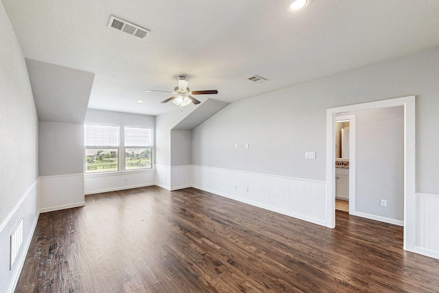 bonus room featuring dark hardwood / wood-style floors, vaulted ceiling, and ceiling fan