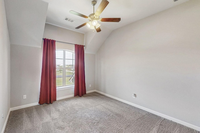 empty room featuring ceiling fan, carpet floors, and vaulted ceiling