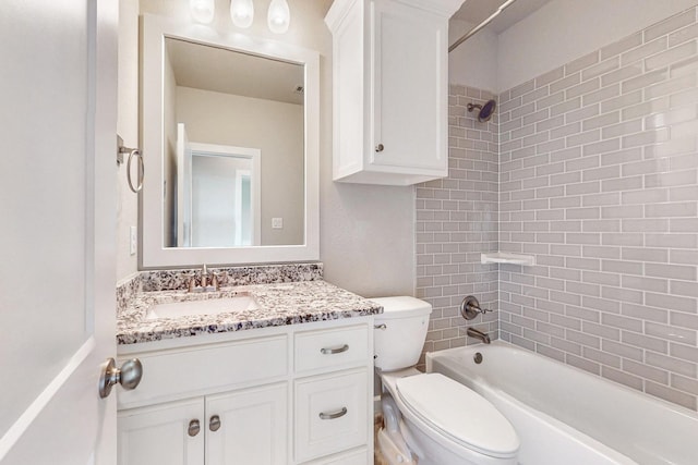 full bathroom with toilet, vanity, and tiled shower / bath