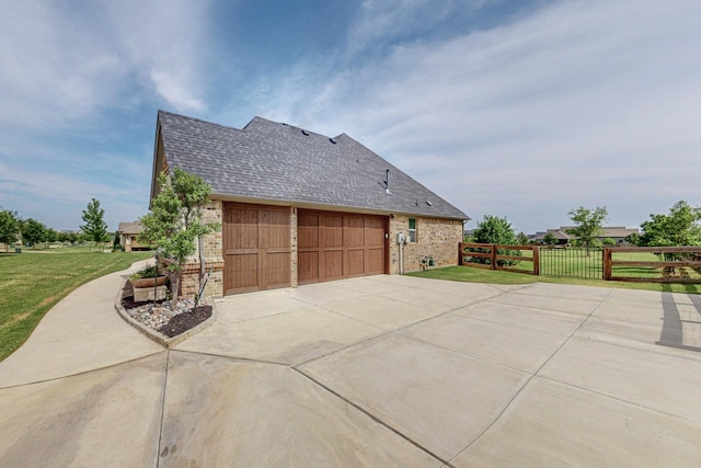 view of home's exterior featuring a garage and a yard