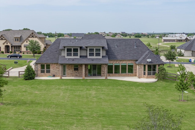 rear view of house featuring a yard