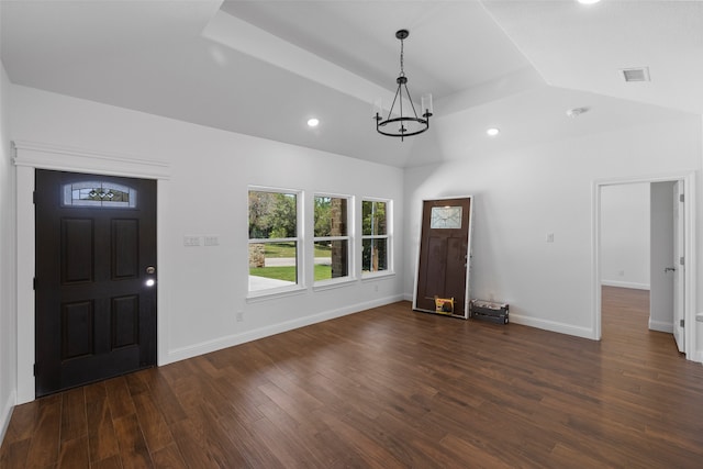 entryway with dark hardwood / wood-style flooring, lofted ceiling, and a notable chandelier