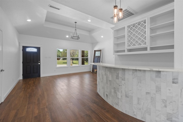 entrance foyer with visible vents, dark wood-type flooring, a raised ceiling, recessed lighting, and baseboards