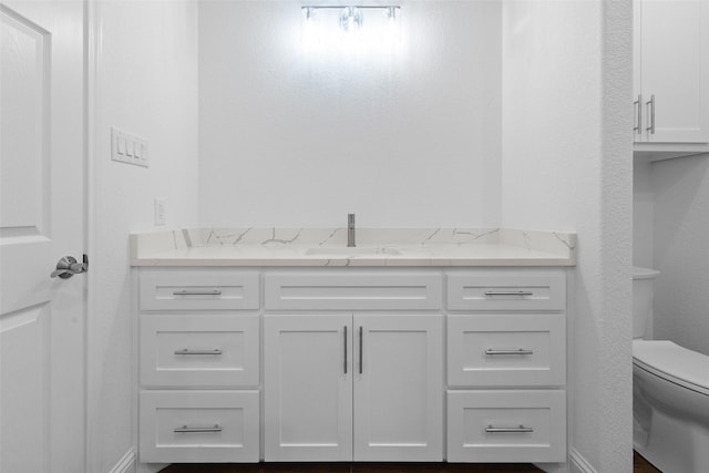 bathroom featuring toilet and vanity