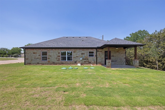 rear view of property featuring a lawn