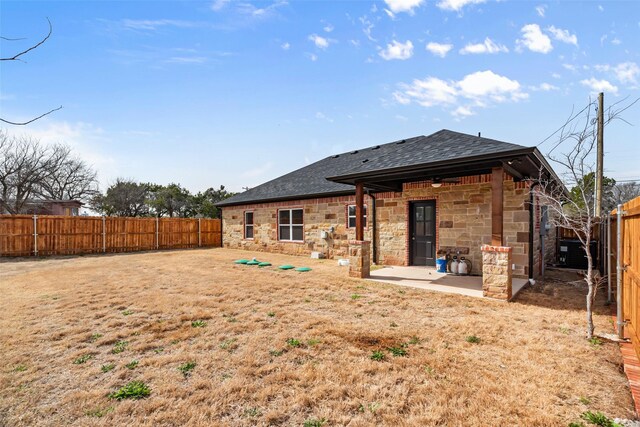 rear view of property featuring a yard