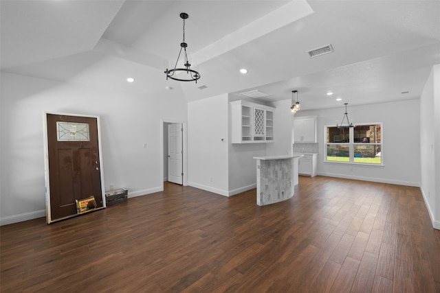 unfurnished living room with dark hardwood / wood-style floors and vaulted ceiling