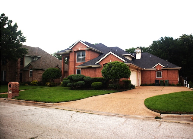 view of front of home featuring a garage and a front lawn