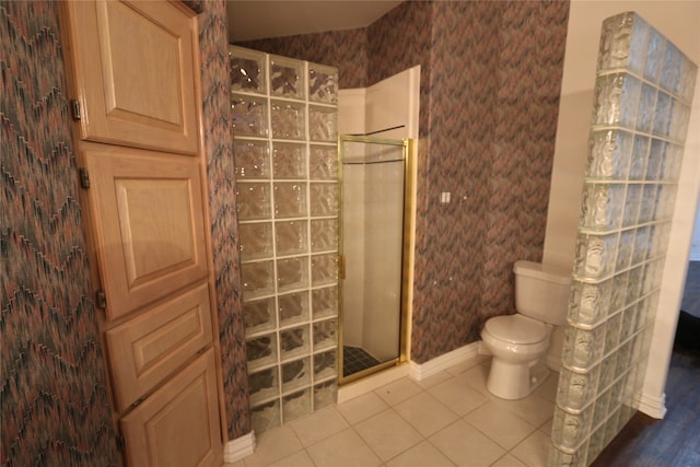 bathroom with walk in shower, tile flooring, and toilet