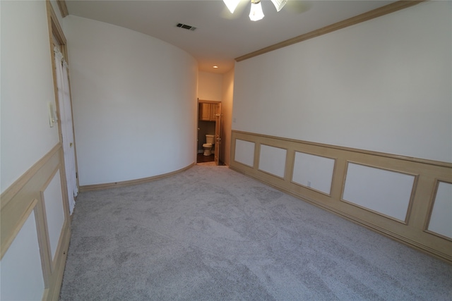 unfurnished room featuring ornamental molding and carpet floors