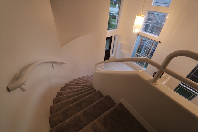 stairs featuring a high ceiling