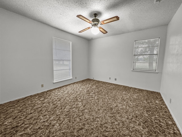 spare room with ceiling fan, carpet floors, and a textured ceiling