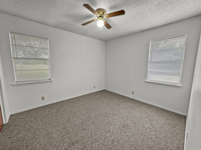 unfurnished room featuring carpet flooring, ceiling fan, plenty of natural light, and a textured ceiling