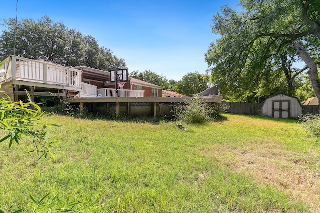 view of yard with a storage shed and a wooden deck