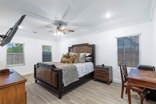 bedroom with light hardwood / wood-style floors, ornamental molding, and ceiling fan