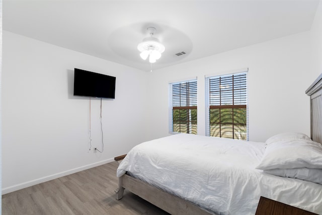 bedroom with ceiling fan and hardwood / wood-style floors