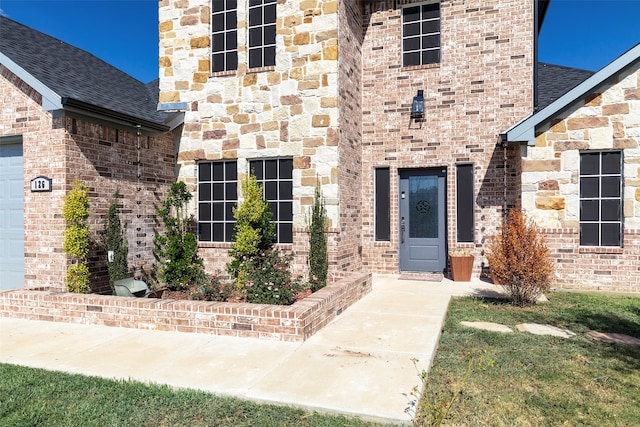 doorway to property with a yard