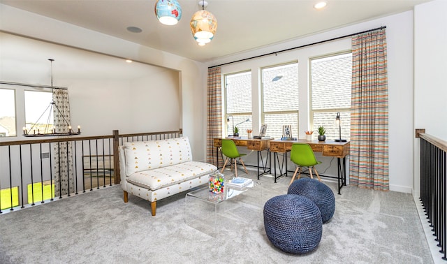 sitting room with a notable chandelier and carpet floors