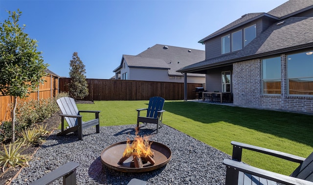 view of yard featuring an outdoor fire pit and a patio area