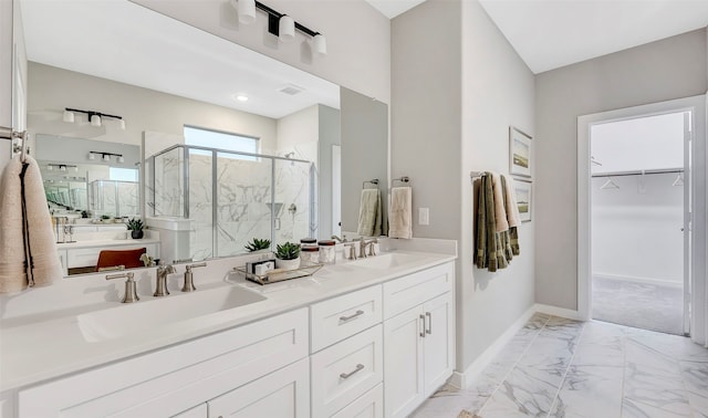 bathroom with tile floors, dual vanity, and a shower with shower door