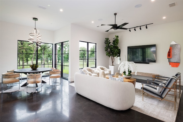 living room with ceiling fan with notable chandelier