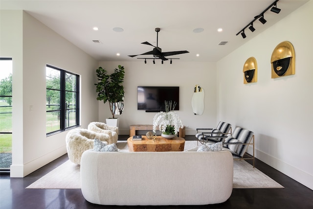 living room featuring ceiling fan and rail lighting