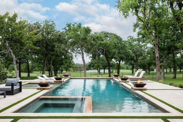 view of swimming pool featuring an in ground hot tub and a patio