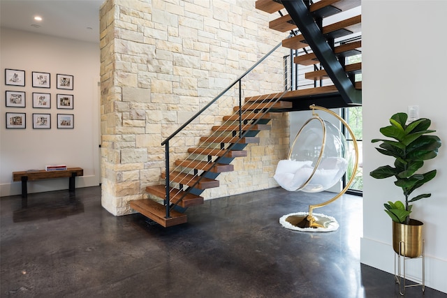 staircase with concrete flooring