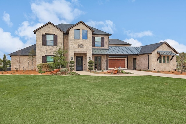 view of front of house featuring a garage and a front lawn